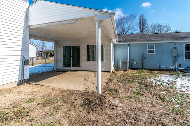 back of property with central AC unit and a patio area