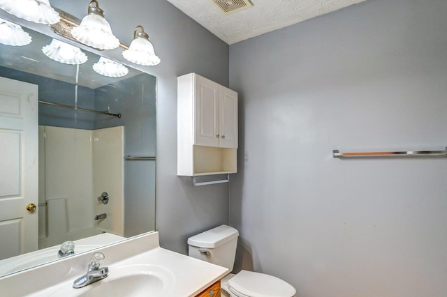 full bathroom with vanity,  shower combination, toilet, and a textured ceiling