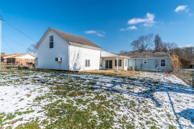 view of snow covered back of property