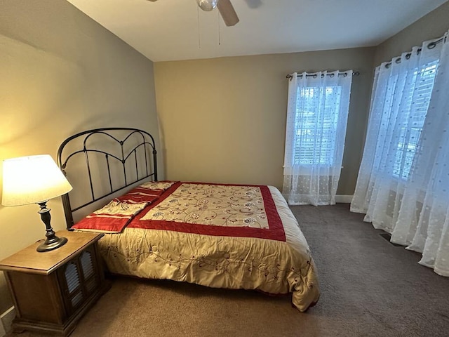 bedroom with ceiling fan and dark carpet