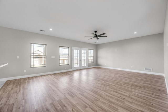 unfurnished room featuring light hardwood / wood-style floors, french doors, and ceiling fan