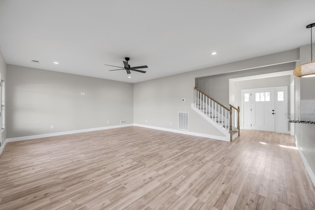 unfurnished living room with ceiling fan and light wood-type flooring