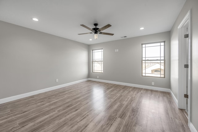 unfurnished room featuring light hardwood / wood-style flooring and ceiling fan