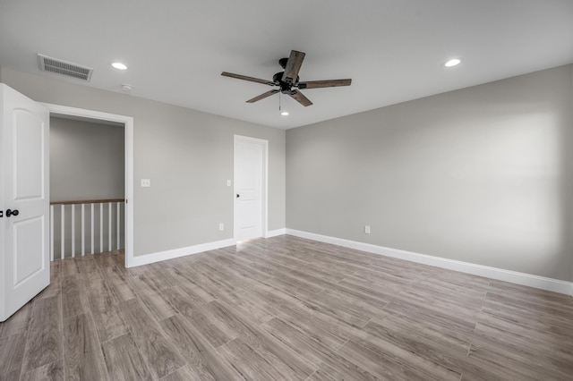 unfurnished room with ceiling fan and light hardwood / wood-style floors