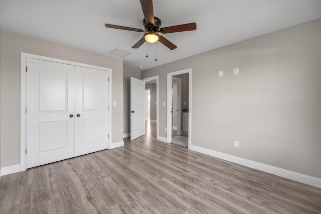 unfurnished bedroom featuring light hardwood / wood-style floors, a closet, and ceiling fan