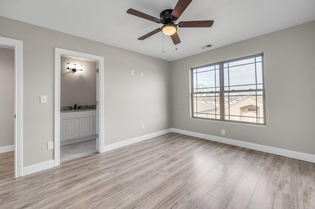 unfurnished room featuring ceiling fan, sink, and light hardwood / wood-style flooring