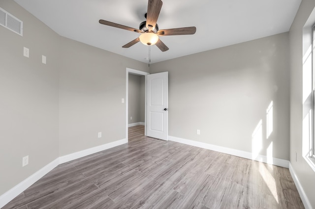 spare room with ceiling fan and light hardwood / wood-style flooring