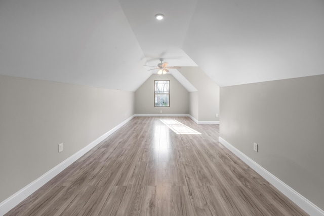 bonus room with lofted ceiling and light hardwood / wood-style flooring