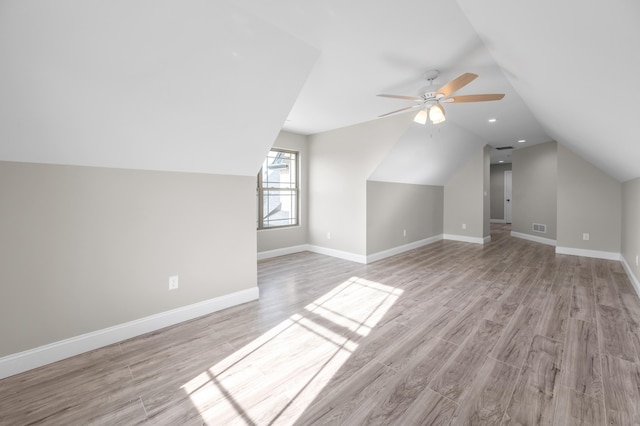 bonus room featuring lofted ceiling, light hardwood / wood-style flooring, and ceiling fan