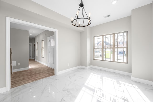 empty room with a notable chandelier