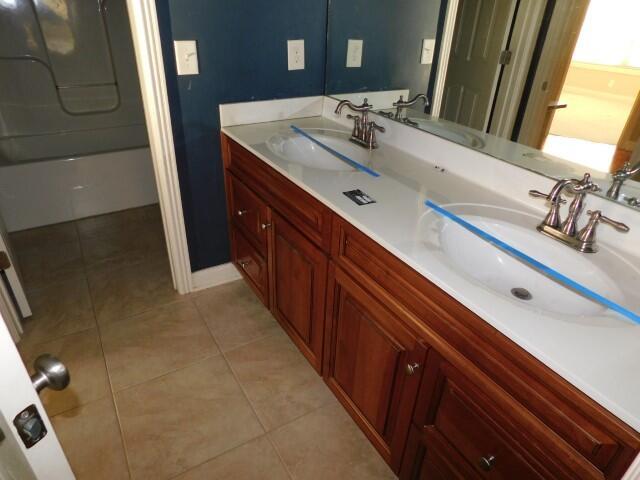 bathroom featuring tile patterned flooring and vanity