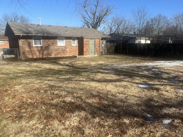 rear view of property with a yard