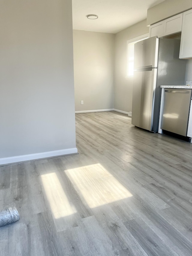 unfurnished dining area with light wood-type flooring