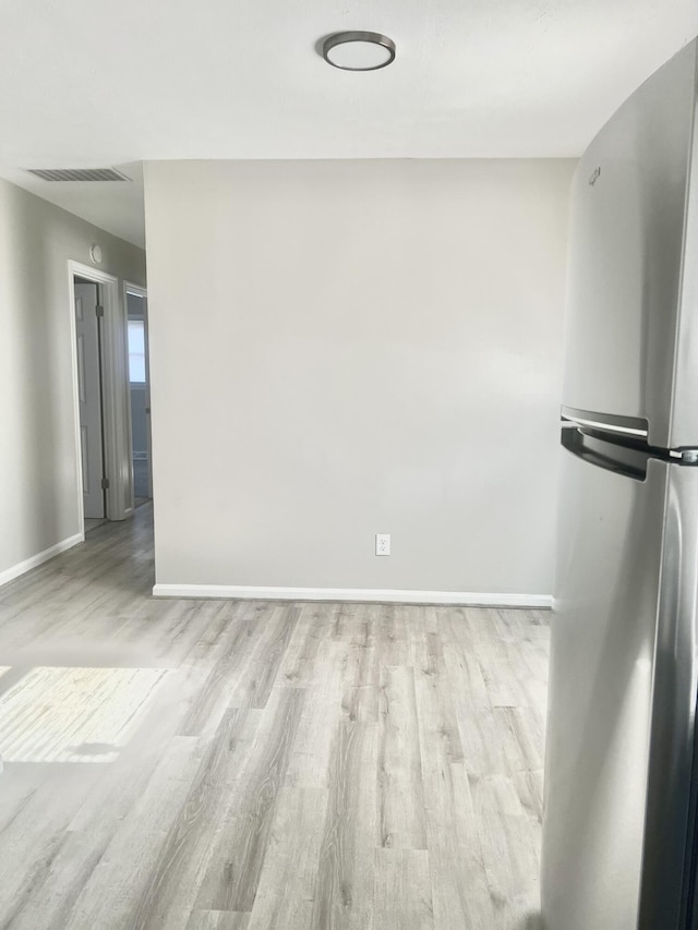 unfurnished room with light hardwood / wood-style flooring