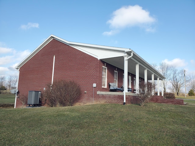 view of home's exterior with central AC and a lawn