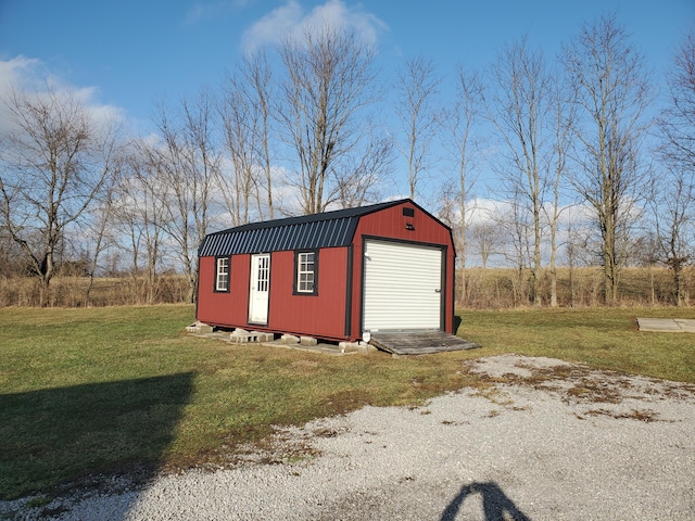 view of outbuilding with a garage and a lawn