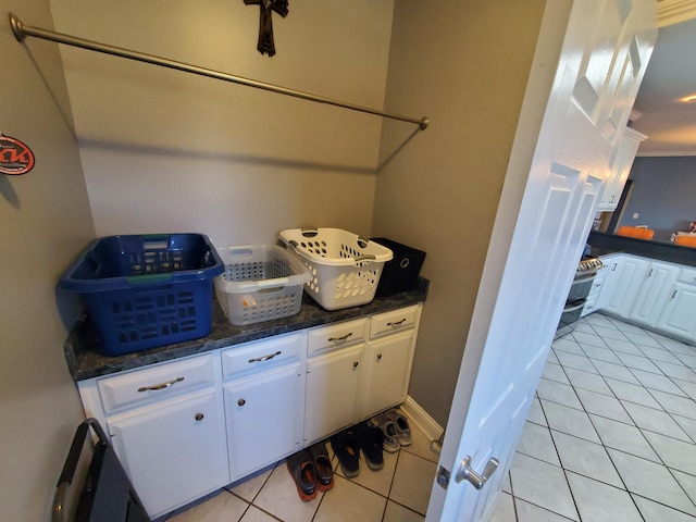 laundry area with light tile patterned flooring