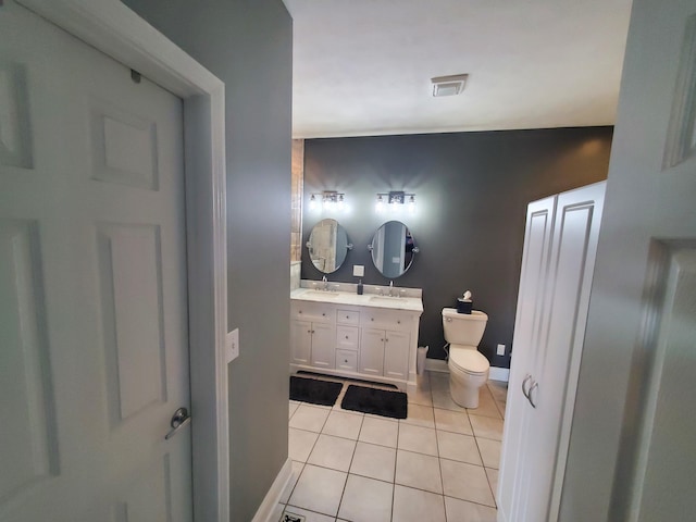 bathroom featuring vanity, tile patterned floors, and toilet