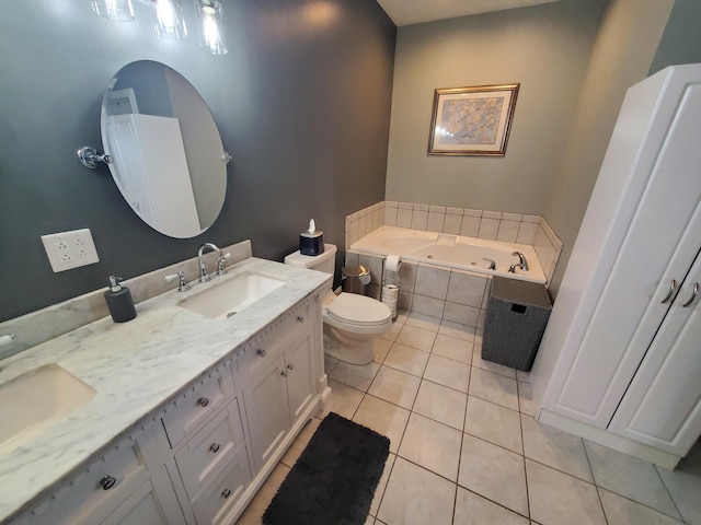 bathroom featuring vanity, tiled tub, tile patterned floors, and toilet