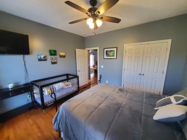 bedroom with hardwood / wood-style floors, a closet, and ceiling fan