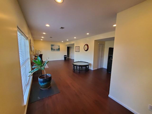 hallway with dark hardwood / wood-style flooring