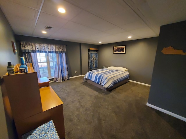 carpeted bedroom with a drop ceiling