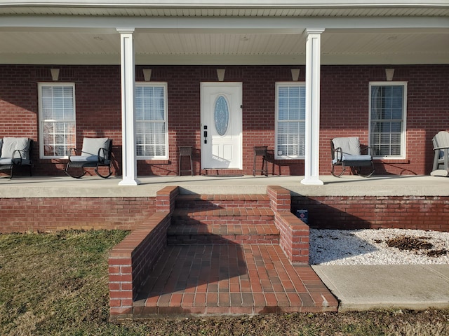 view of exterior entry with covered porch