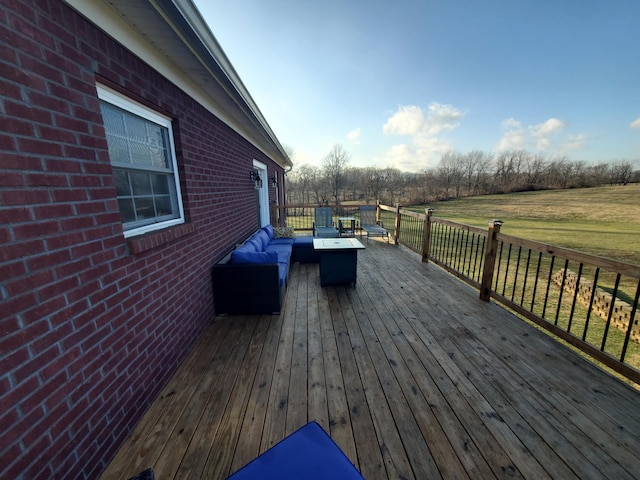 wooden terrace with outdoor lounge area and a yard