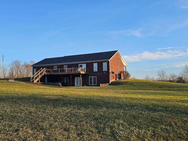 rear view of house featuring a yard, cooling unit, and a deck