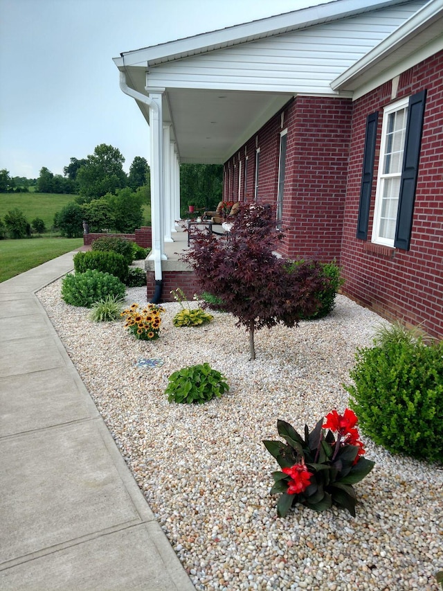 view of side of property featuring covered porch