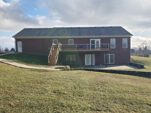 rear view of property with a patio, a yard, and a wooden deck