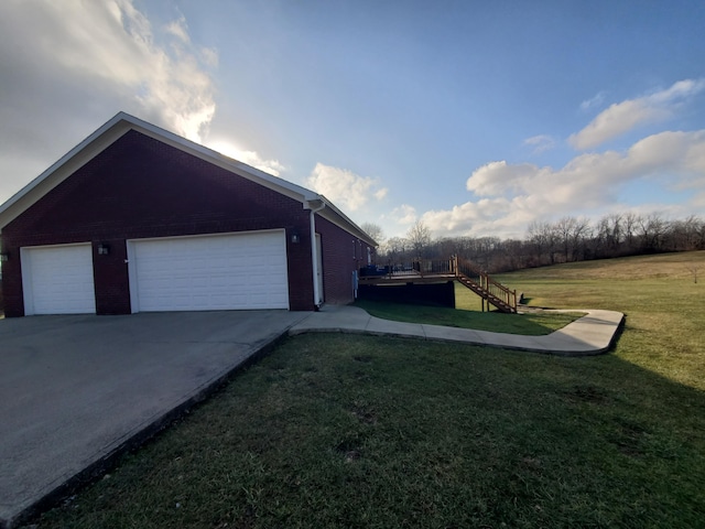 view of home's exterior with a garage and a yard