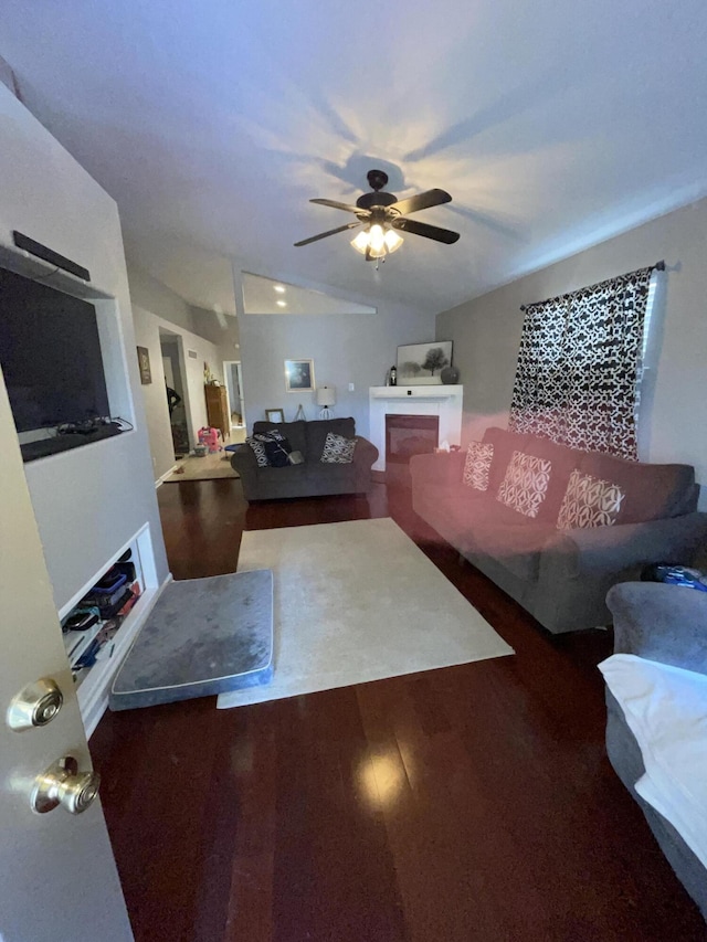 living room with lofted ceiling, dark wood-type flooring, and ceiling fan