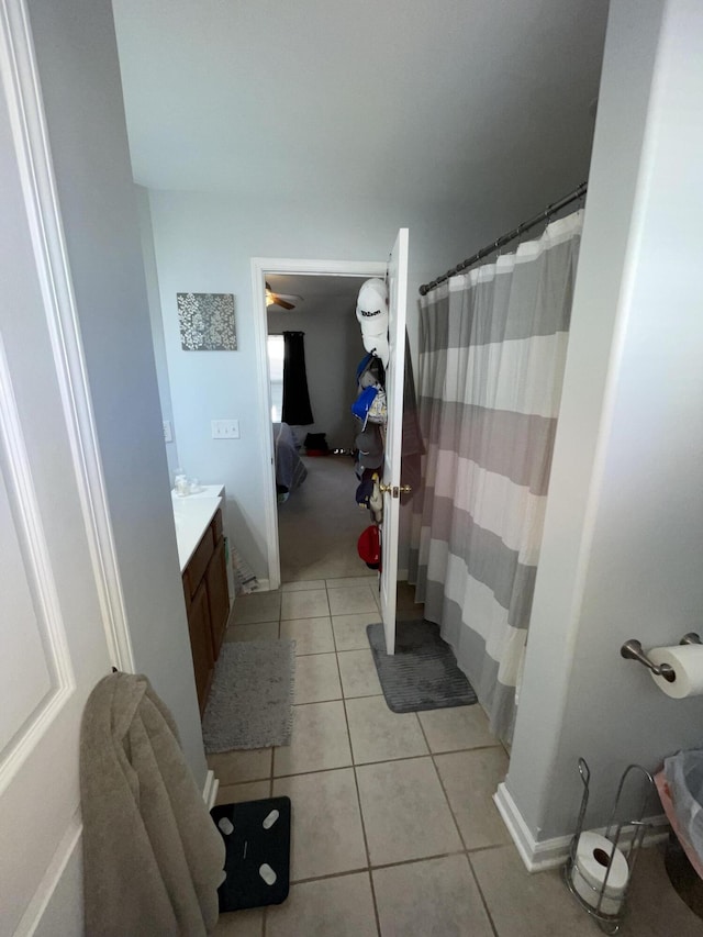 ensuite bathroom with ensuite bath, vanity, and tile patterned floors