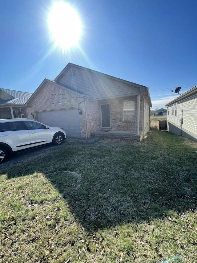 view of front of house with a garage and a front lawn