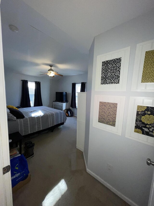 bedroom featuring carpet, baseboards, and ceiling fan