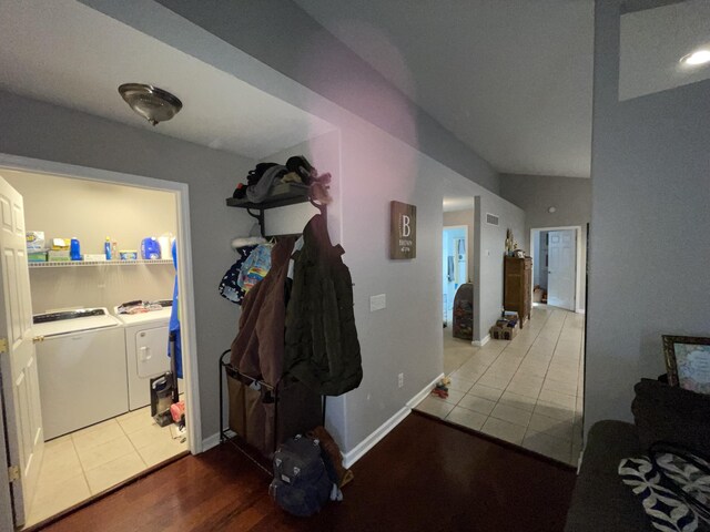 kitchen featuring lofted ceiling, light tile patterned floors, dishwasher, a notable chandelier, and pendant lighting