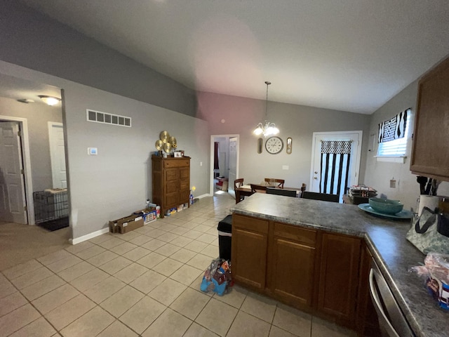 kitchen featuring dark countertops, visible vents, hanging light fixtures, and lofted ceiling