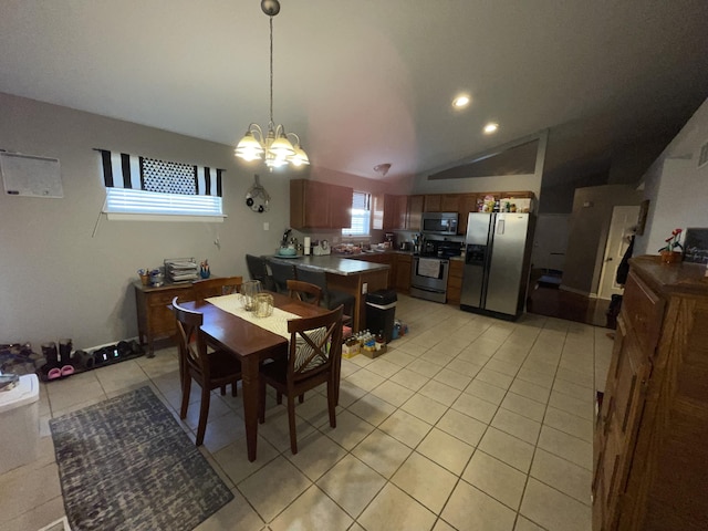 dining space featuring light tile patterned floors, vaulted ceiling, and a notable chandelier