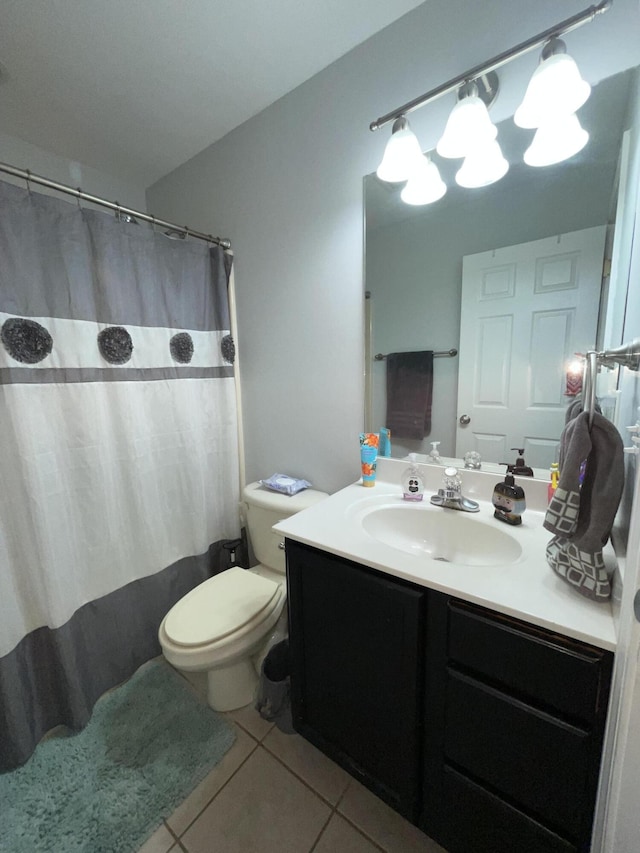 full bath featuring toilet, vanity, a shower with shower curtain, and tile patterned floors