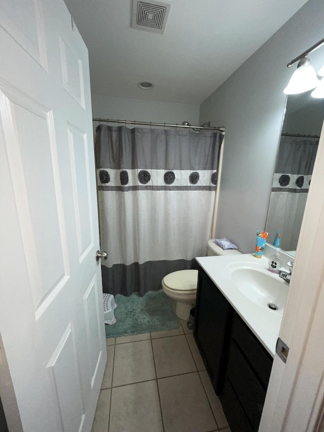 bathroom featuring tile patterned flooring, visible vents, vanity, and toilet