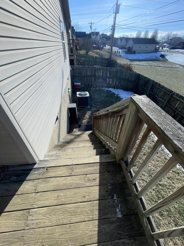 wooden deck featuring central AC unit and fence