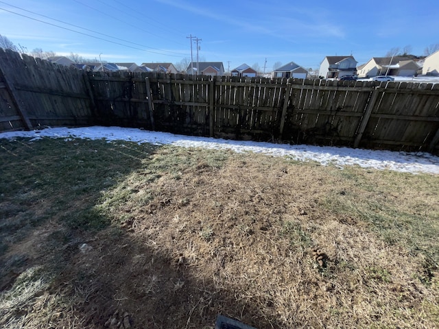 view of yard with a residential view and a fenced backyard