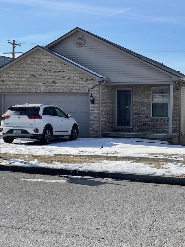 view of front facade with an attached garage and brick siding