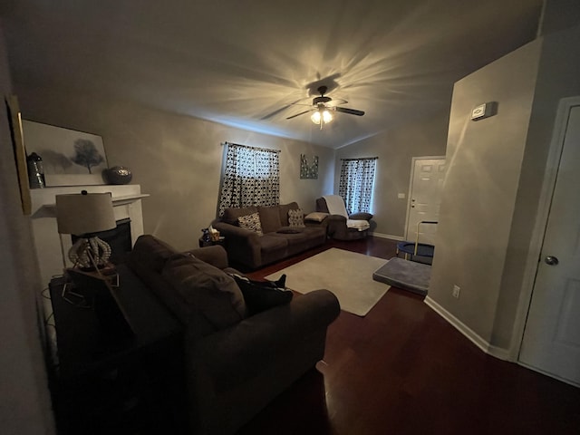 living area featuring lofted ceiling, a fireplace, and baseboards