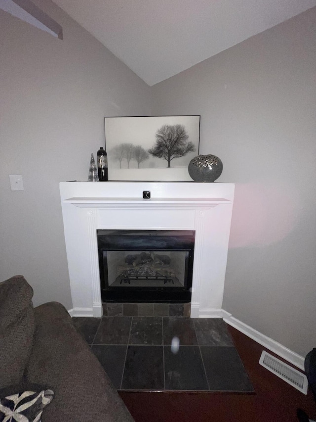 details with a fireplace with flush hearth, visible vents, and baseboards