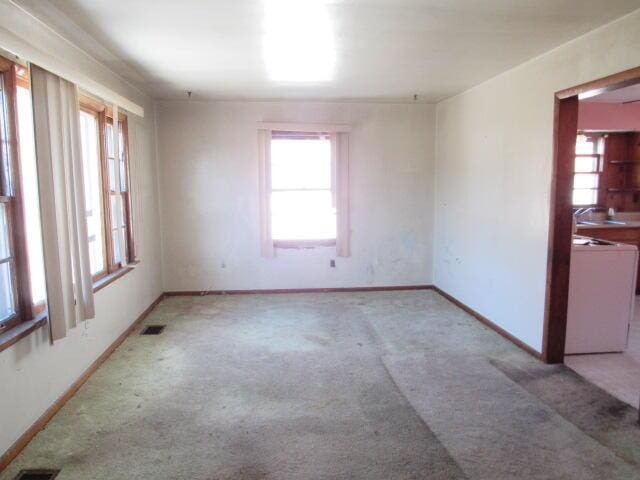 carpeted spare room with a healthy amount of sunlight