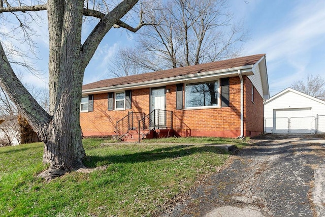 view of front of property with a garage, an outdoor structure, and a front yard