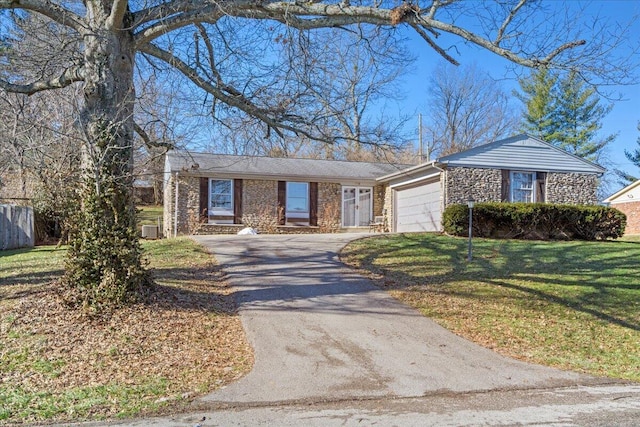 single story home featuring a garage and a front lawn