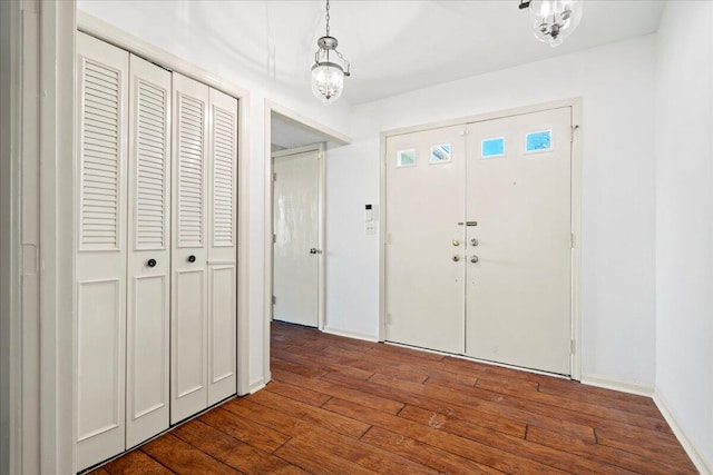 foyer entrance featuring dark wood-type flooring